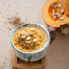 delicious composition with pumpkin soup in a beautiful ceramic dish.
